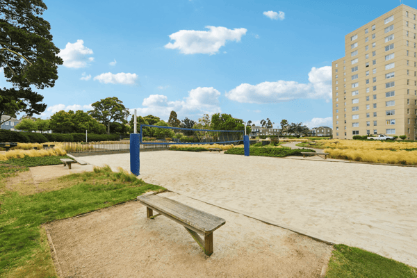 Outdoor volleyball court with a building in the background
