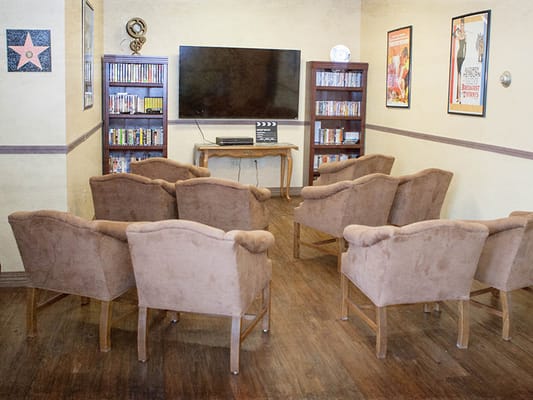 A cozy common area with comfortable seating and a TV