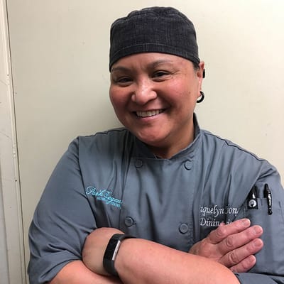 Chef smiling in a kitchen setting