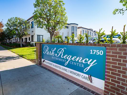 Exterior view of Park Regency Retirement Center with sign