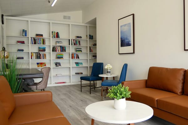Bright interior of a common area with seating and bookshelves