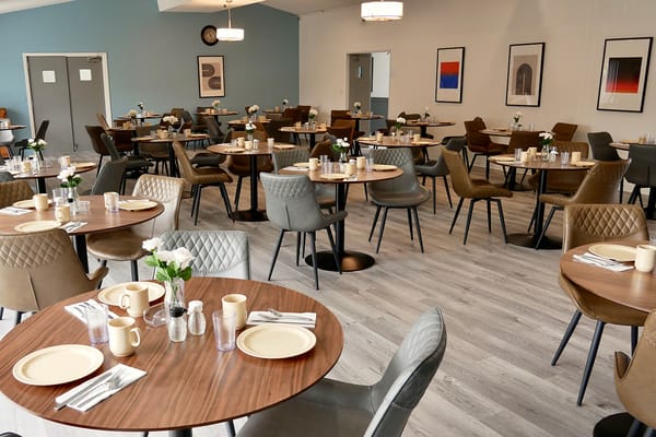 Bright dining room with set tables and modern decor