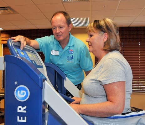 Staff assisting resident during therapy session