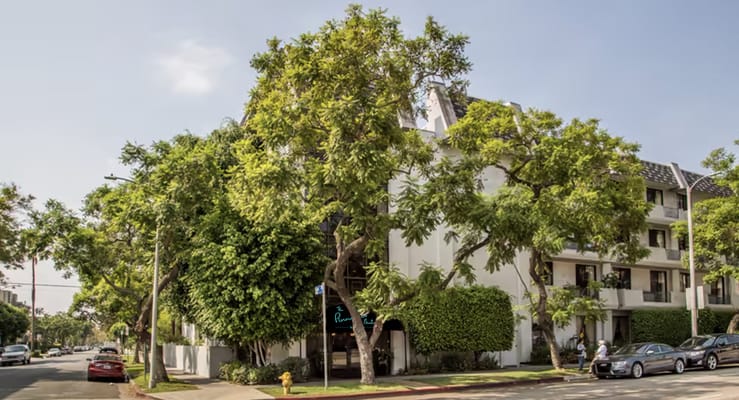 Exterior view of a senior living facility with trees