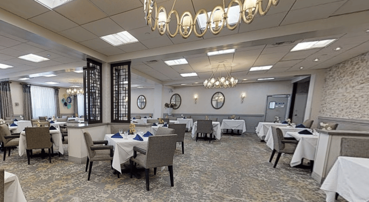 Elegant dining room with tables set for residents
