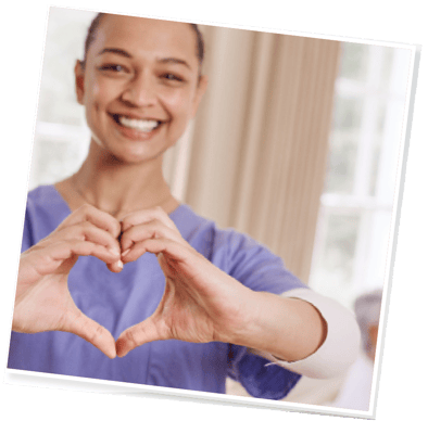 Nurse showing heart hand gesture in a sunny room