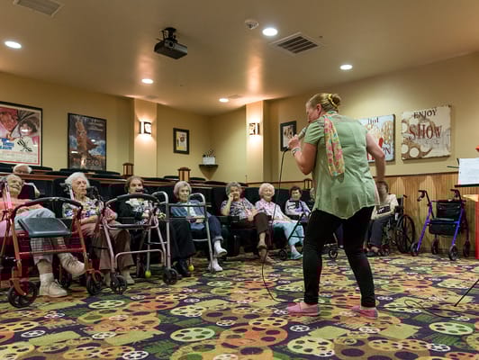 A performer engaging with residents in a common area