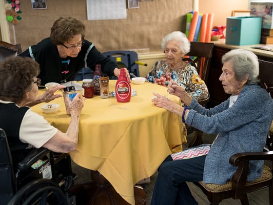 Residents engaged in a social activity over snacks