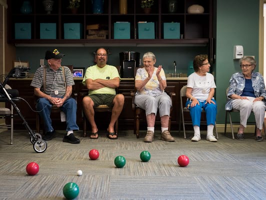 Residents participating in an indoor bocce ball game