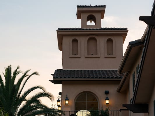 Exterior view of a senior living facility building at sunset