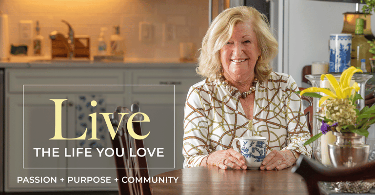 Senior resident smiling in a common area with a cup