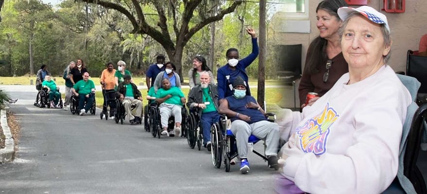 Residents in wheelchairs participating in an outdoor activity
