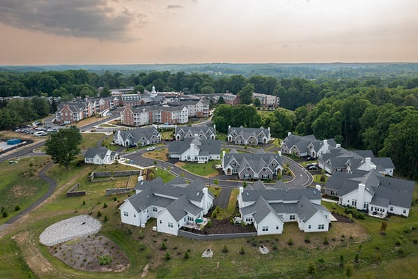 Aerial view of a senior living community with buildings and greenery