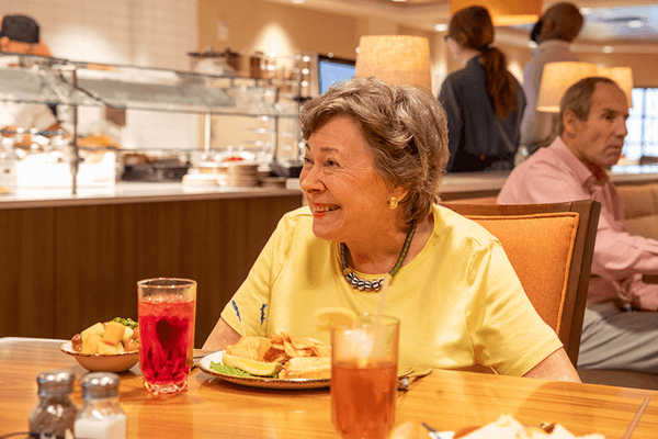 Resident enjoying a meal in the dining area