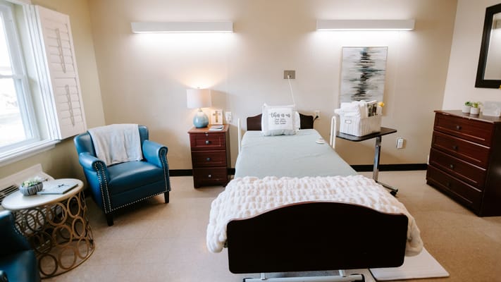 Well-furnished private resident room with bedside table