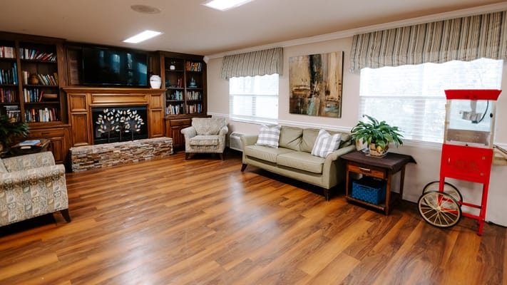 Bright and inviting common area with seating and a fireplace