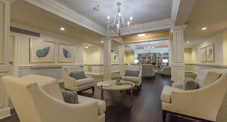 Bright common area with comfortable seating and bookshelves