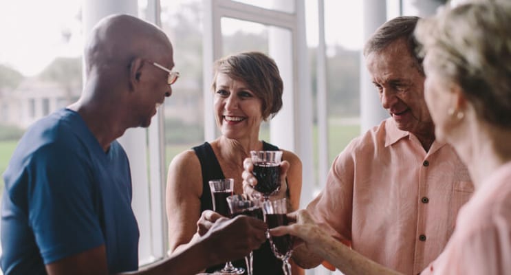 Residents celebrating with drinks in a common area