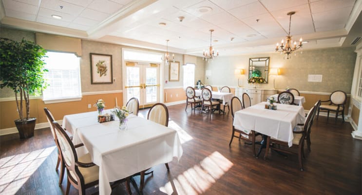 Bright dining room with tables set for meals