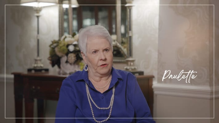 A resident speaking in a well-decorated interior setting