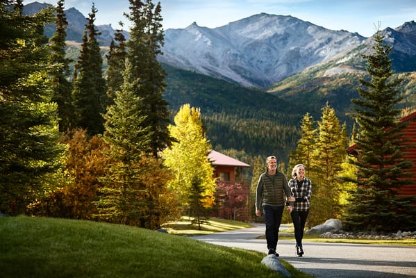 Couple walking in a scenic outdoor area with mountains
