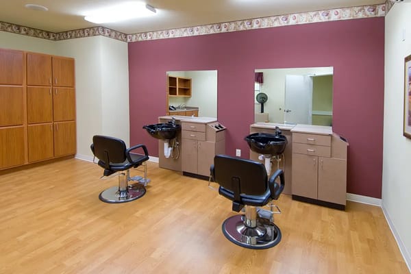Interior of a hair salon area with chairs and mirrors