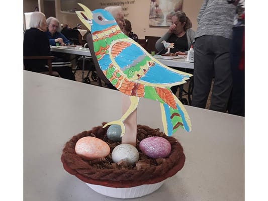 Residents participating in an indoor craft activity