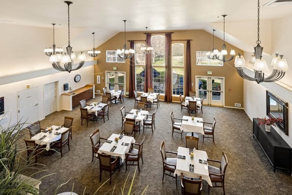 Dining area with tables and chairs set for a meal