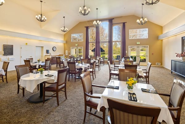 Bright dining room with tables set for meals