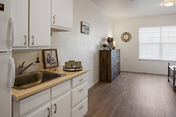 Interior view of a resident's room with kitchenette