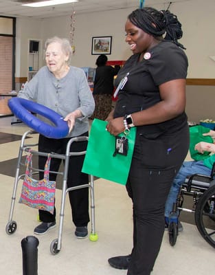Resident interacting with staff in a common area