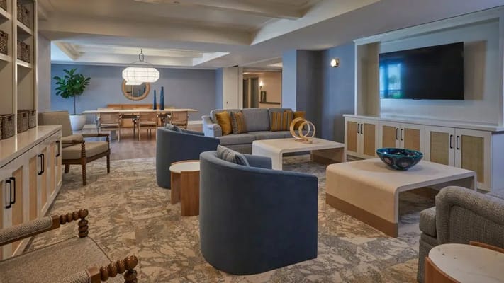 Bright common area with seating and a dining space