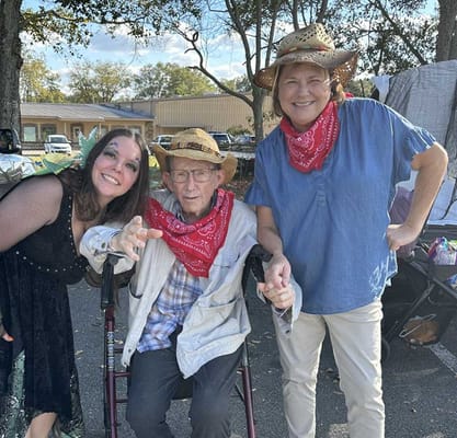 Residents and staff in festive attire outdoors