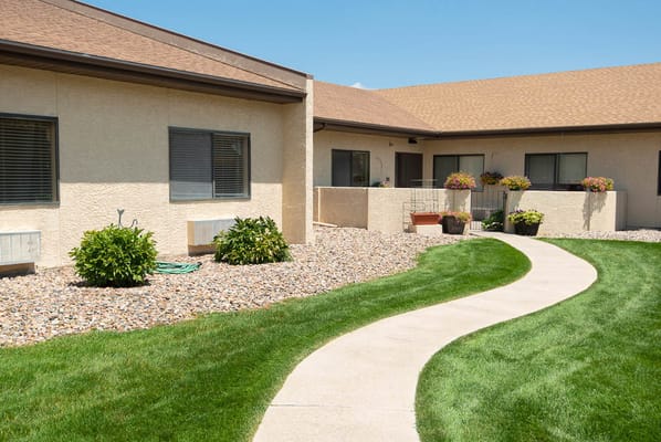 Curved pathway through landscaped garden outside the facility