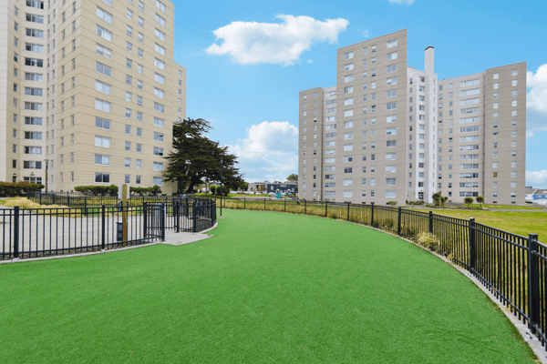Outdoor space with artificial grass and nearby buildings