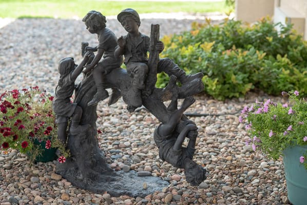 Bronze statue of children playing outdoors