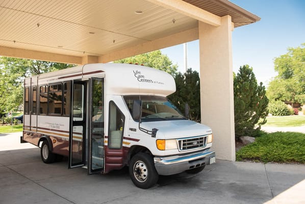 Facility shuttle bus parked at the entrance