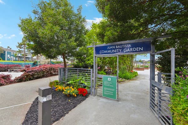 Entrance to the community garden with flowers and greenery