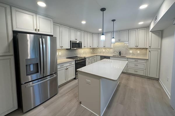 Modern kitchen with stainless steel appliances and bright lighting