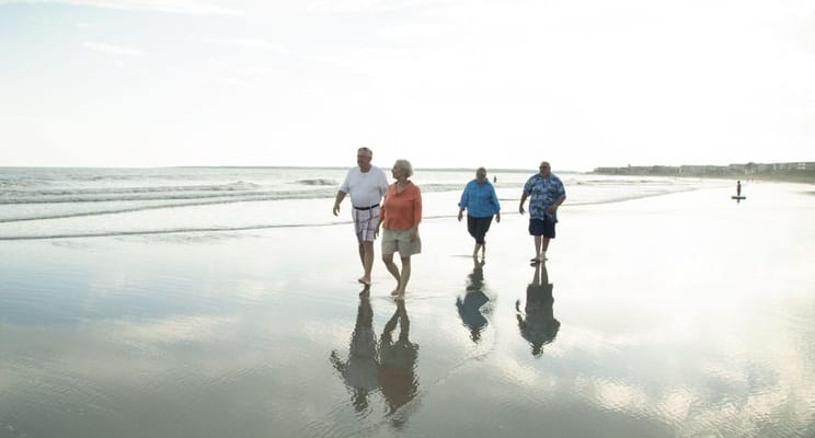 Residents enjoying a walk on the beach