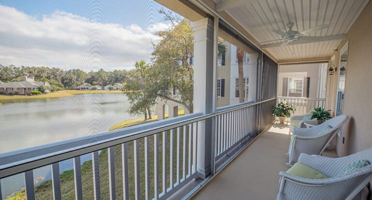 Screened porch view overlooking a serene lake