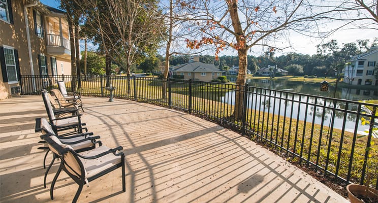 Outdoor seating area overlooking a serene pond