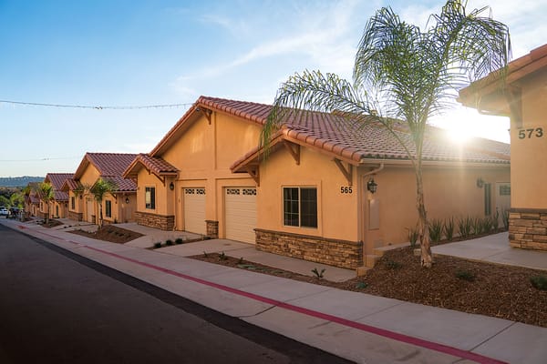 Building exterior of independent living units with palm trees