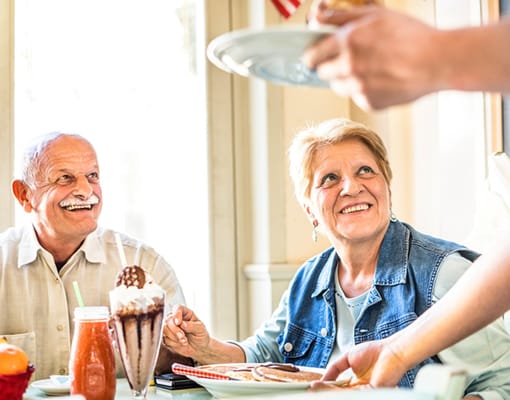 Residents enjoying a meal together in the dining area