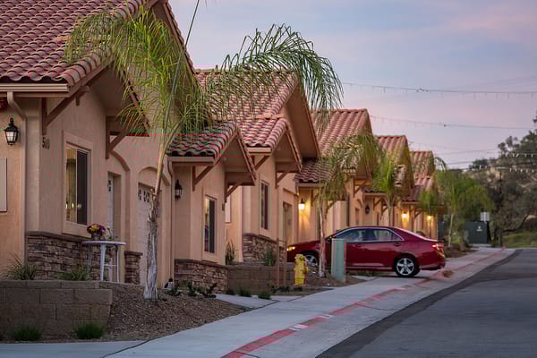 Row of residential cottages with palm trees