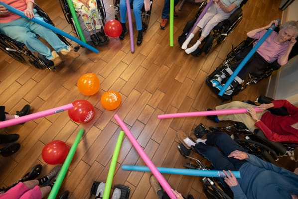 Residents engaging in an activity with foam noodles
