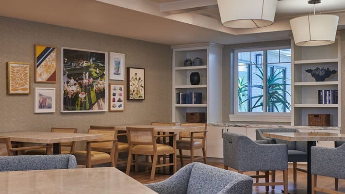 A modern common area with tables and artwork