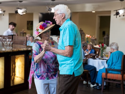 Residents dancing at a festive event in a common area