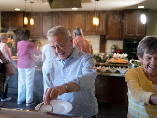 Residents enjoying a meal together in the dining area