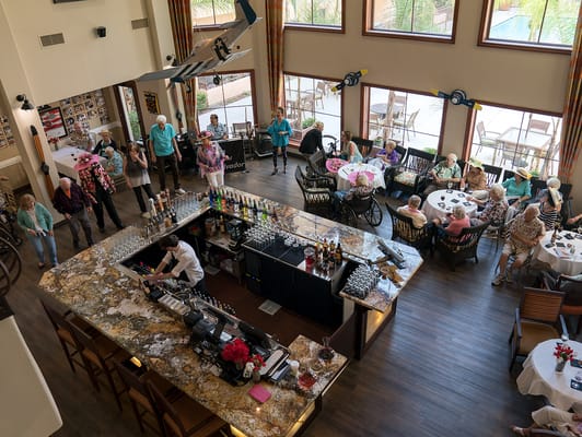 Residents enjoying a meal in a dining room.